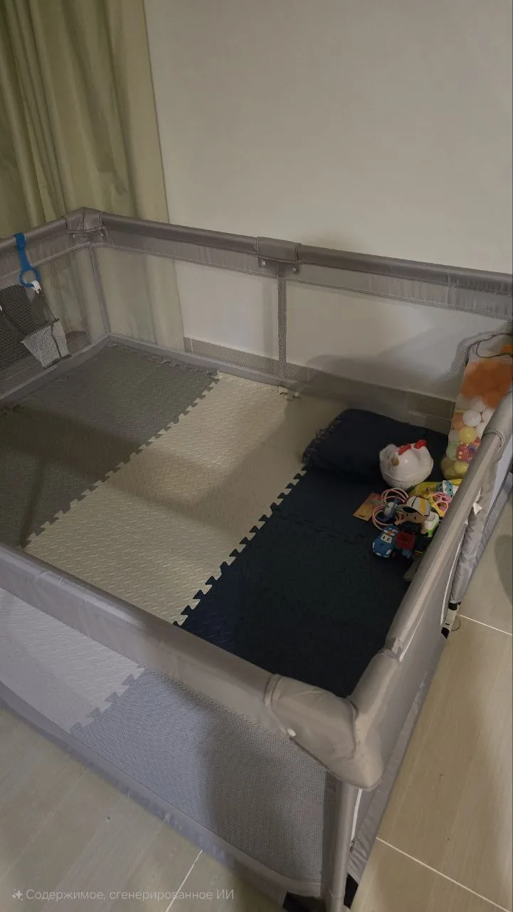 Indoor playpen with foam mats and toys, suggesting a pre-loved baby item setup in a UAE home
