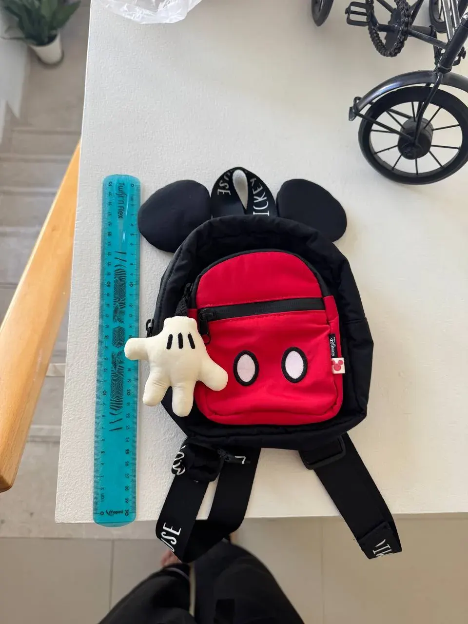 Used Mickey Mouse backpack with a ruler and toy glove, suitable for free school supply swaps in the UAE Used Mickey Mouse backpack with a ruler and toy glove, suitable for free school supply swaps in the UAE