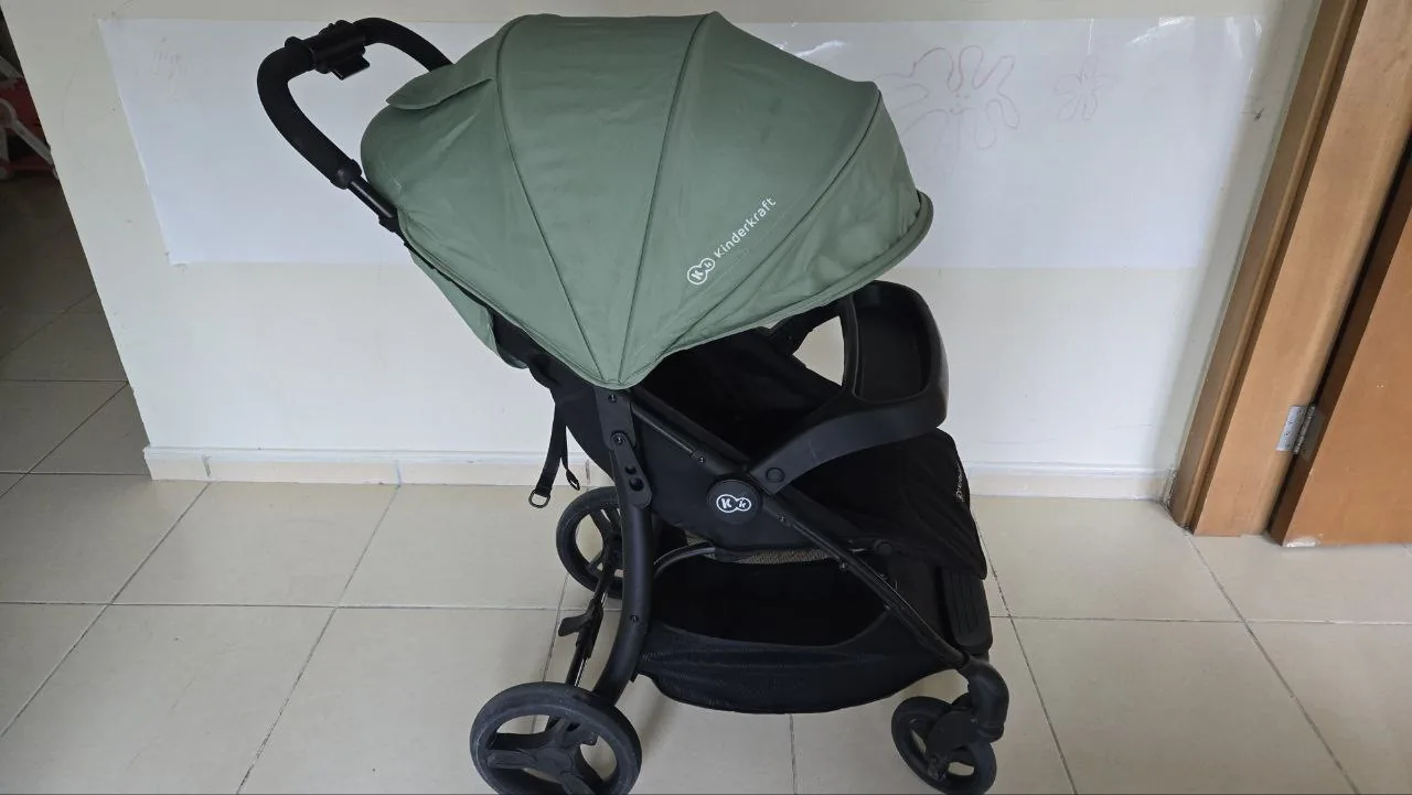 Used baby stroller indoors, representing second-hand baby gear available in Dubai