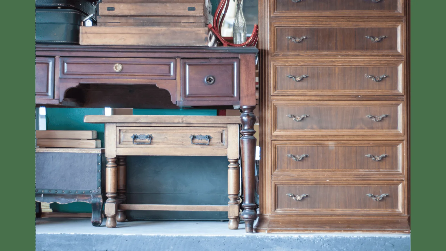 Old wooden dressers and table indoors, representing used furniture ready for removal or resale in Dubai