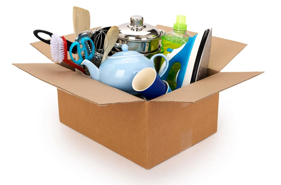 Open cardboard box with assorted household items ready to be given away