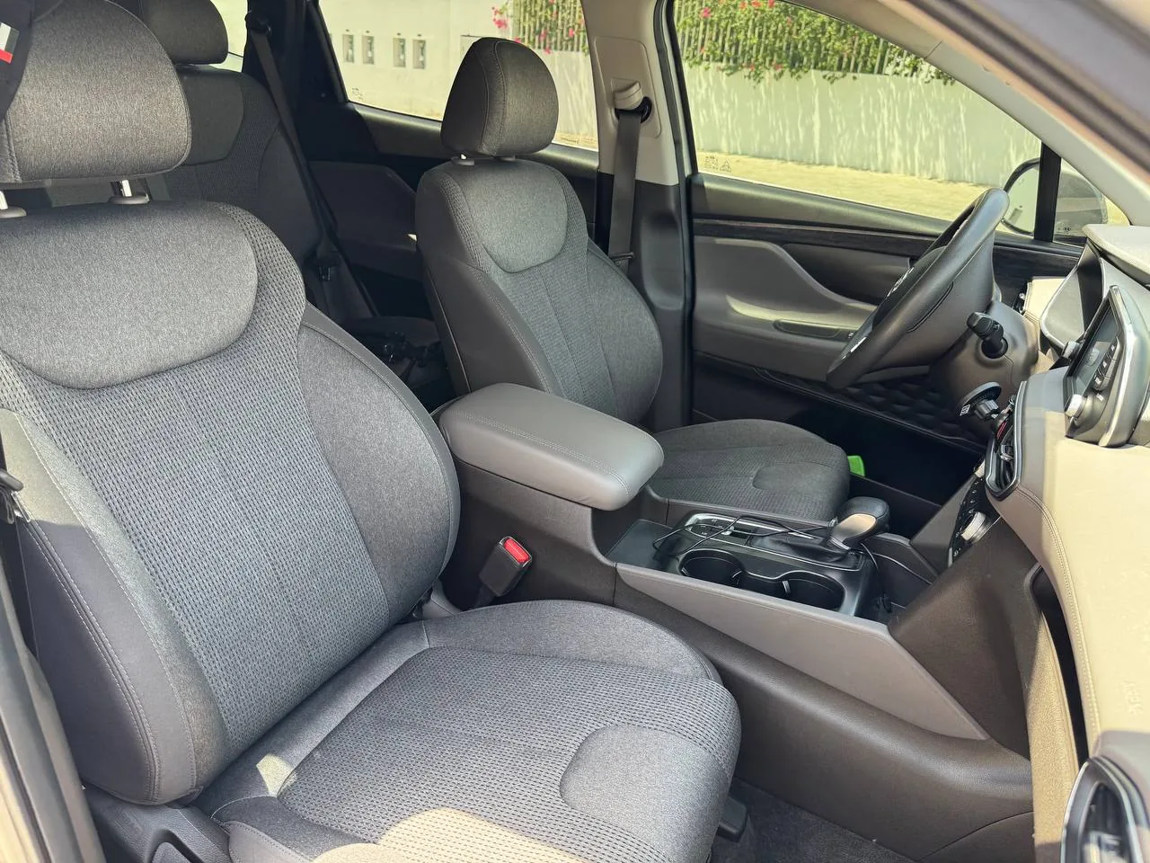 Interior of a car with front seats and center console, used as a generic illustration for junk collection services in the UAE