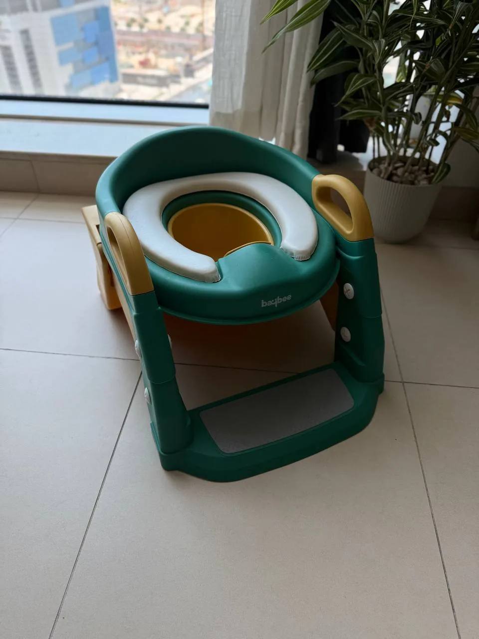 Reusable baby toilet trainer on a stand, showing how children’s items can be passed on instead of thrown away Reusable baby toilet trainer on a stand, showing how children’s items can be passed on instead of thrown away