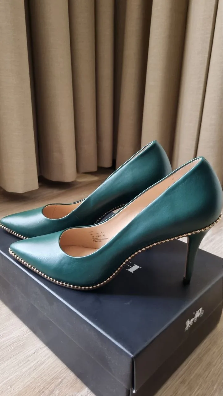 High-heeled pumps on a shoe box representing fashion items that could participate in a token reward ecosystem in the UAE