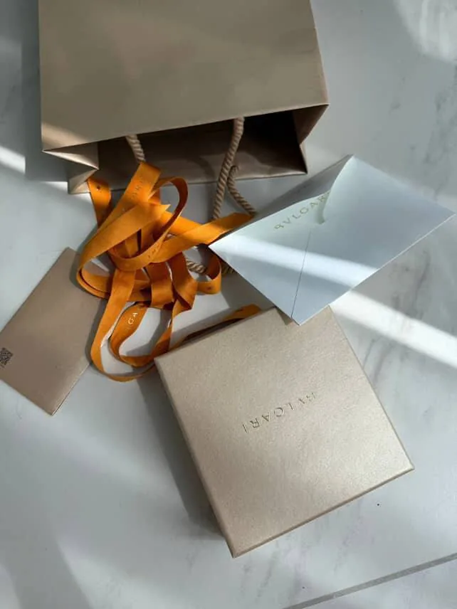Neatly wrapped gift boxes with orange ribbon suggesting thoughtful, low-waste gifting