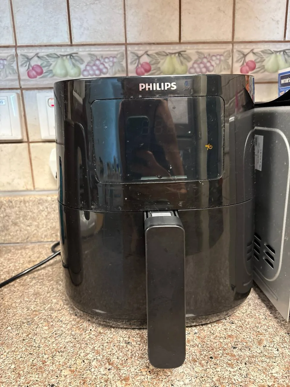 Black Philips air fryer on a kitchen counter, representing a modern home appliance upgrade option