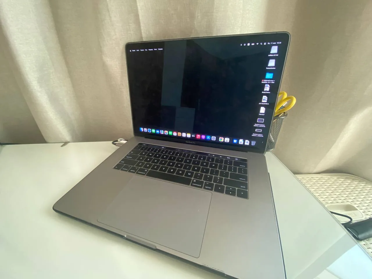 Laptop workspace on a tidy home desk with stationery holder, suggesting a small business run from home