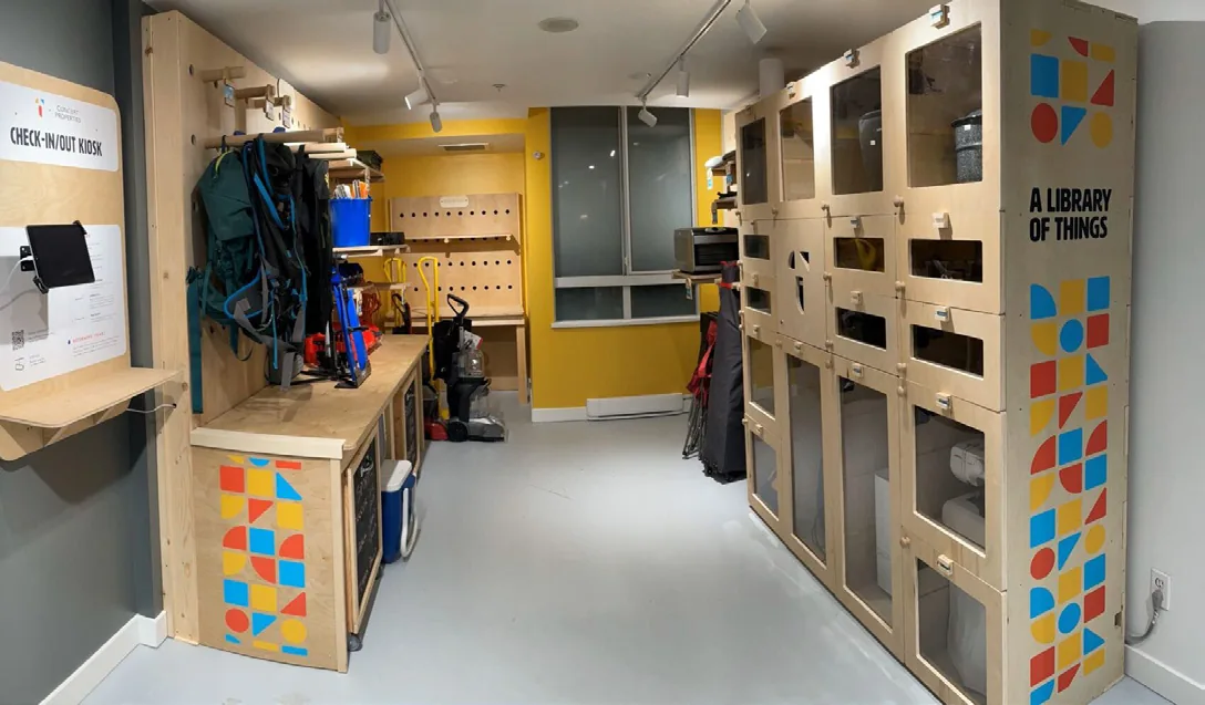Makerspace-style checkout area with lockers and a check-in kiosk for borrowing and reusing shared items